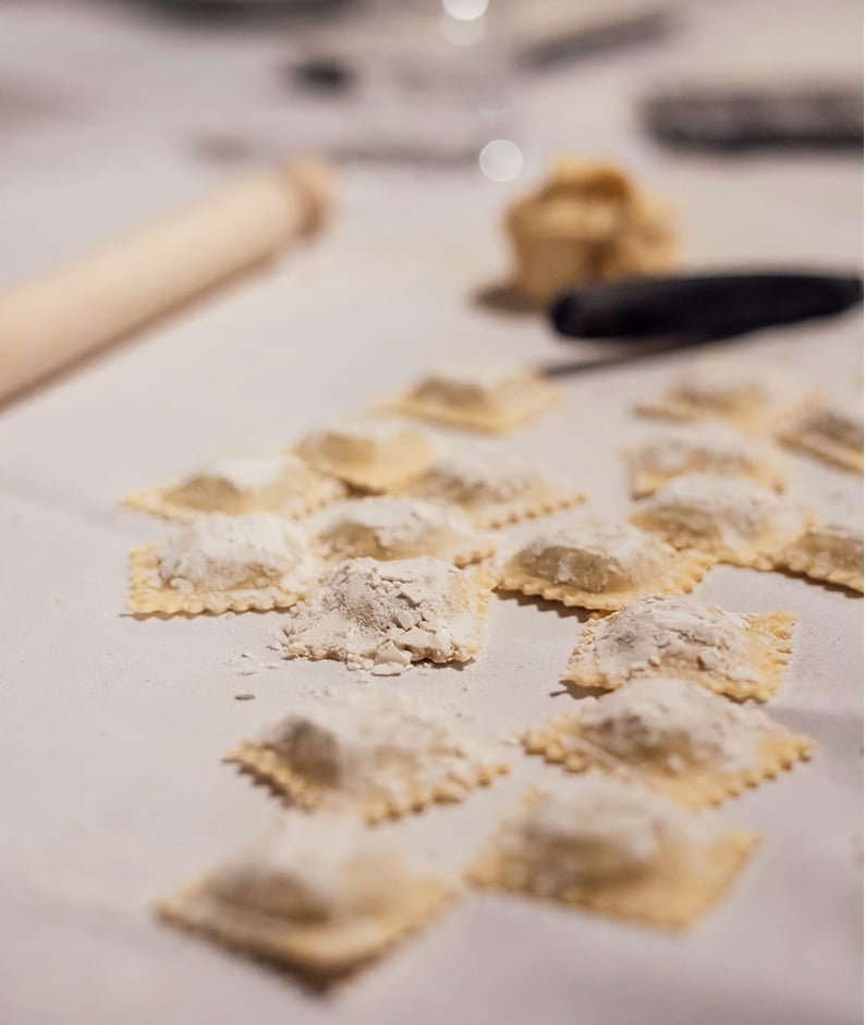 Learn to make pasta, ravoli pasta strewn across a counter